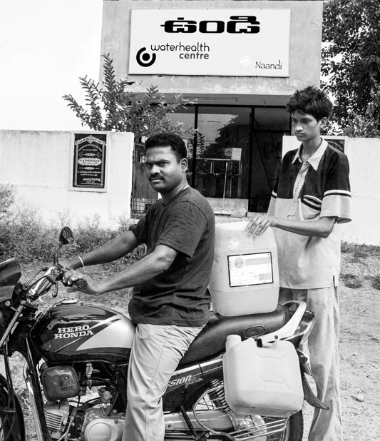 Carrying safe drinking water purchased from a Reverse Osmosis (RO) plant near Kolleru Lake in West Godavari district, Andhra Pradesh